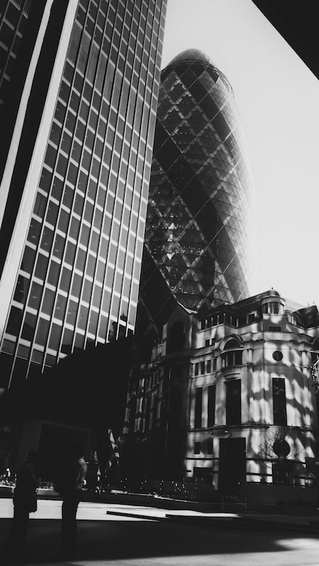 The Gherkin building in London in black and white with heavy shadows